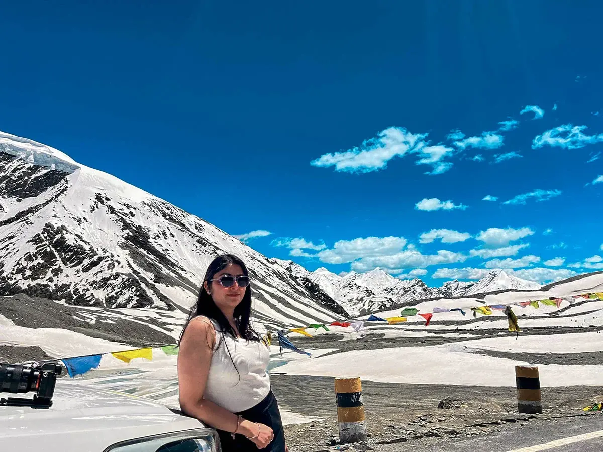 High-altitude view of Shinku La Pass with snow patches and rugged trail